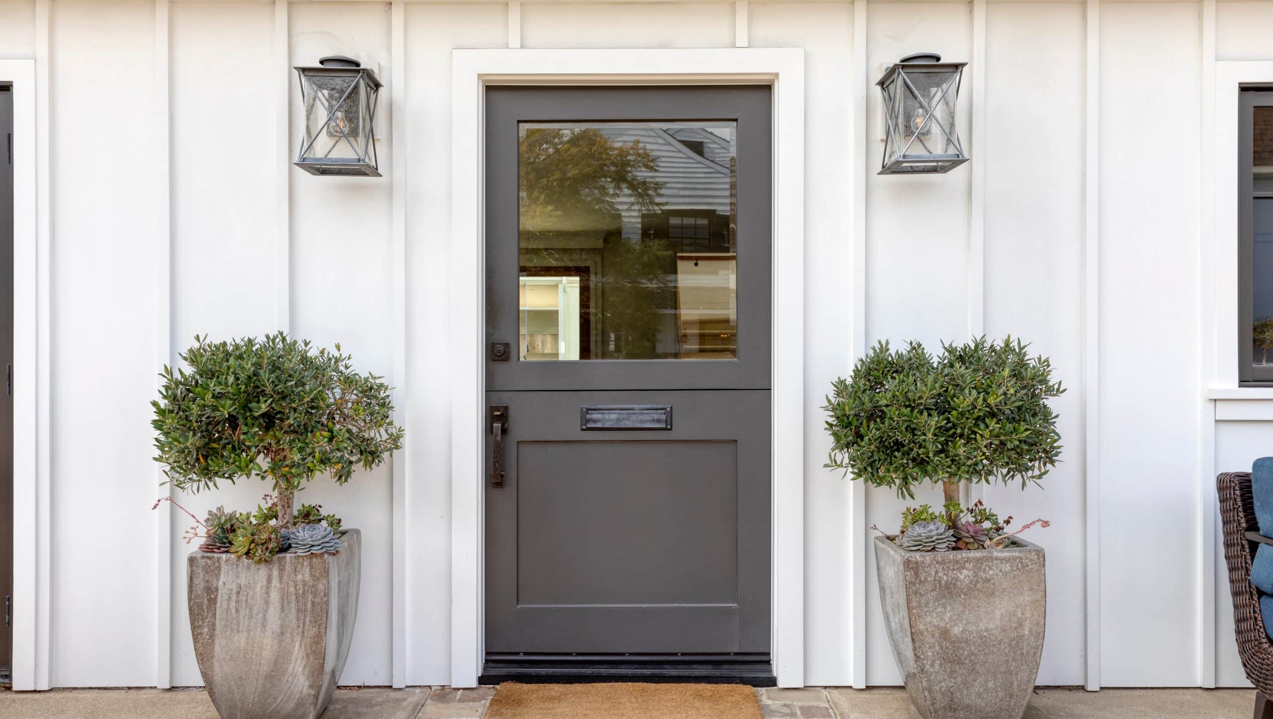 A lovely gray door against a white home in St Johns, FL for Jacksonville Doors & Windows