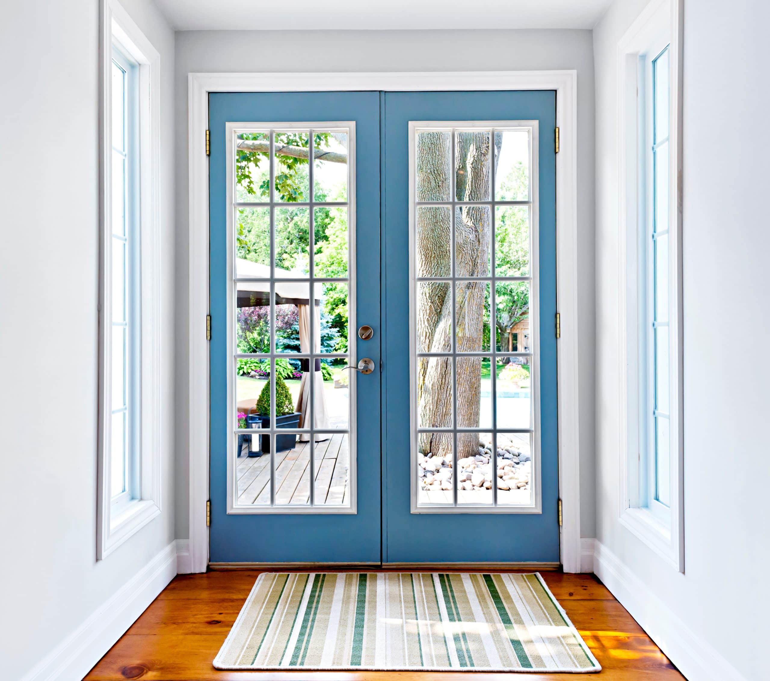 Double blue and white doors with 12 panes and patio outside